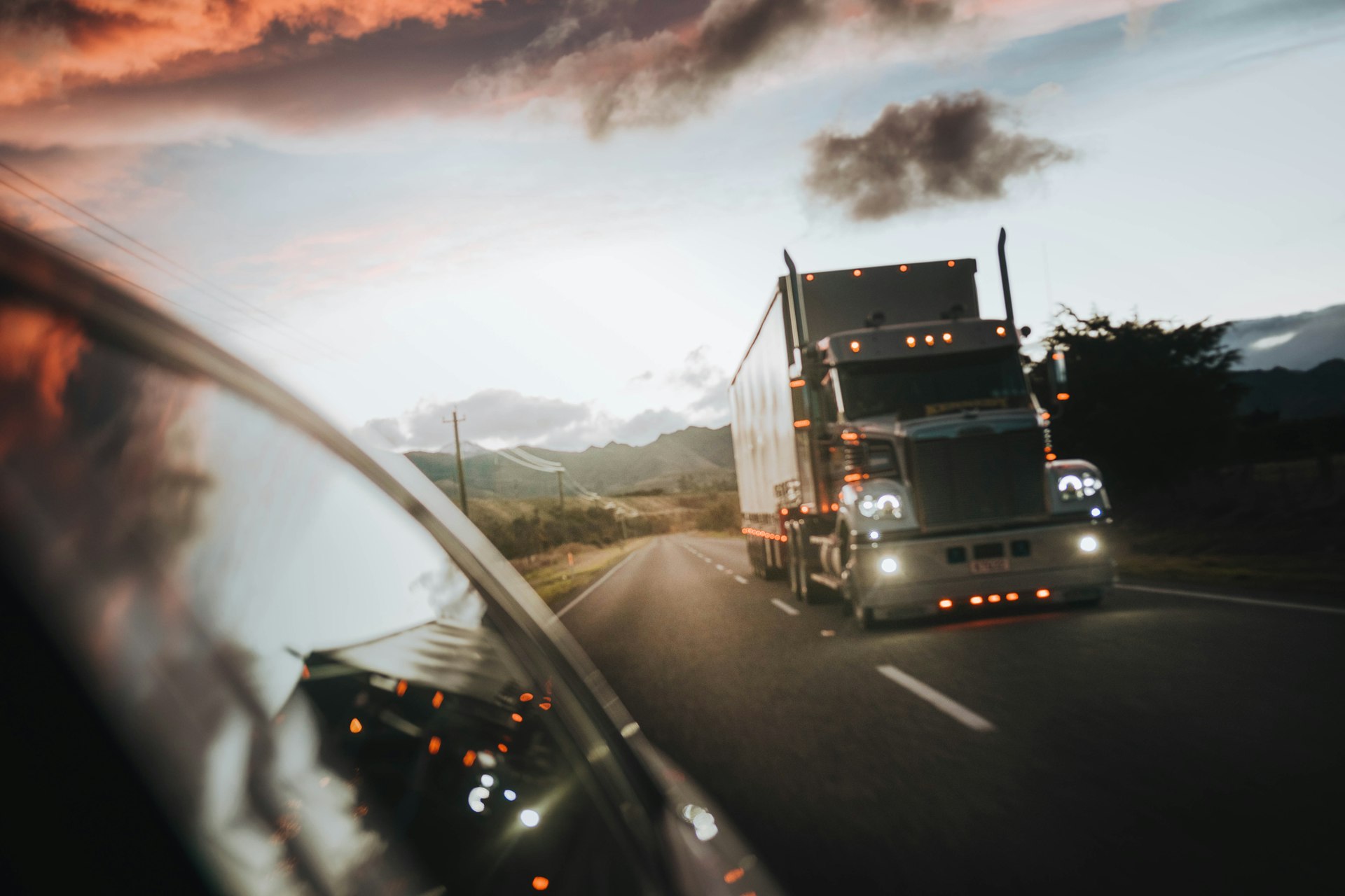 Semi truck on the road at sunset